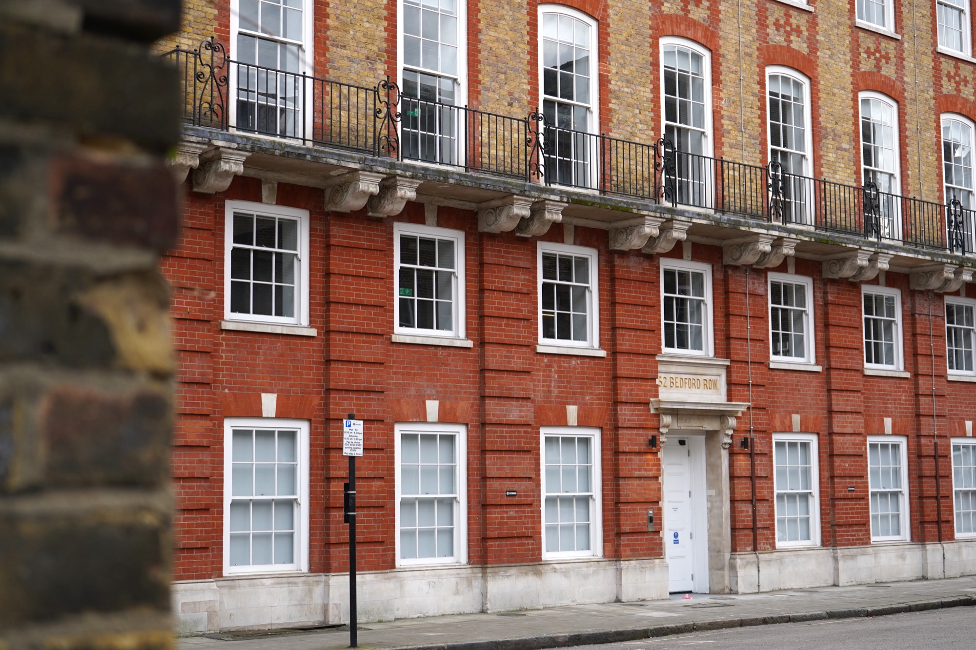 The red-brick exterior of Juntos House at 52 Bedford Row, Holborn