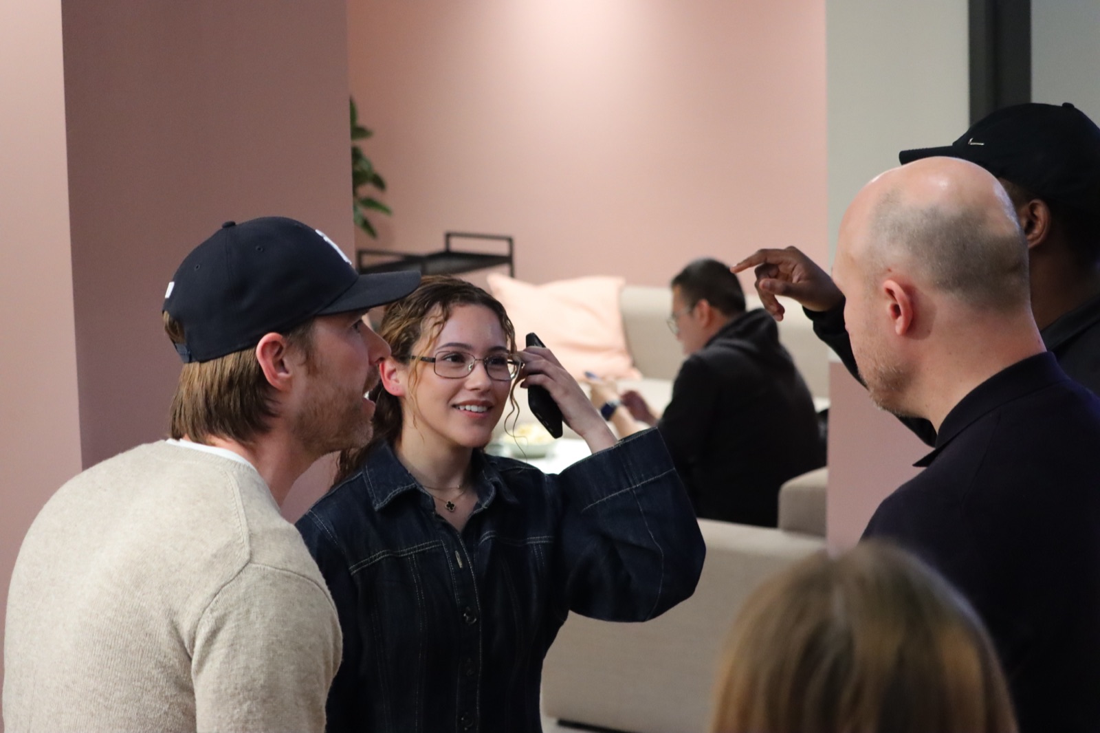 Members chatting at a late-night social in the pink lounge at Juntos Bedford Row