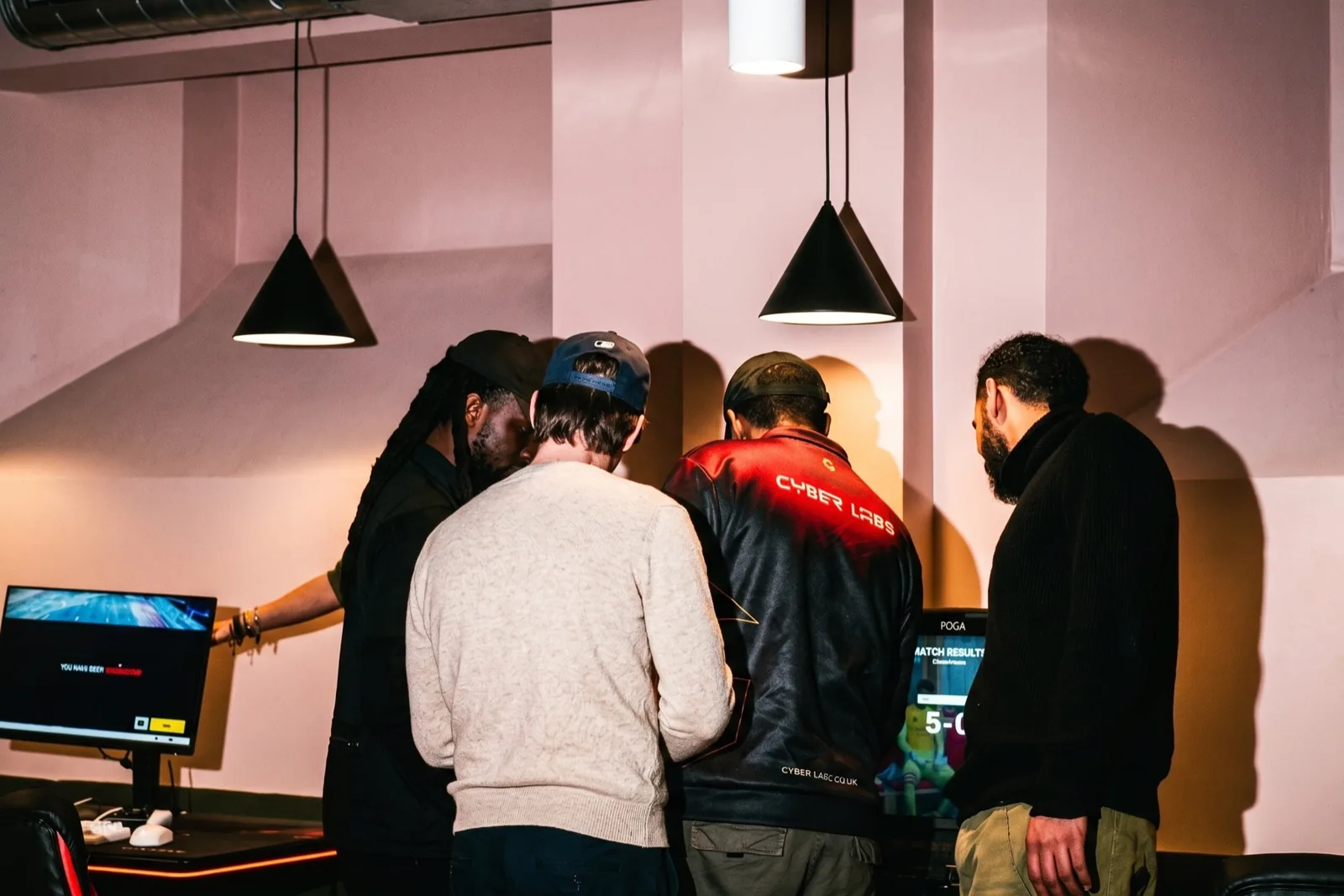 Members at a Juntos event — group gathered around the screen, laughing